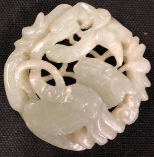 Chinese Carved Jade: Description: Luminous Chinese jade carving. Circular-shaped, depicting a long necked bird amid florals and resting on a circular base that lends this piece dimension. Carved from very pale, cool