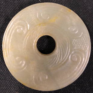 Carved Chinese Jade Disc/Pendant: Description: Carved Chinese jade disc/pendant with detail work on both sides. Carved from pale green-hued jade. Jade has been the most highly esteemed stone in China throughout recorded history, and