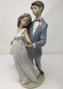 Lladro Porcelain Now and Forever # 7642: Description: Lladro Porcelain, Now and Forever # 7642, dancing couple; retired. Female dancer is missing an arm; no other damage. Material: porcelain. Measurement: approximate 11" (INCHES).