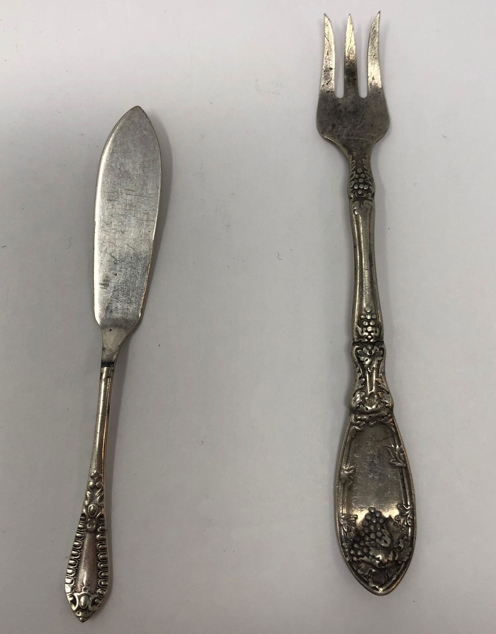 Antique Knife and Fork: Description: Petite antique butter knife and three pronged fork in silver plate. Lovely etched handles; fork is marked with Rogers imprint, 1881, A1. Butter knife has English hallmarks. Material: silv
