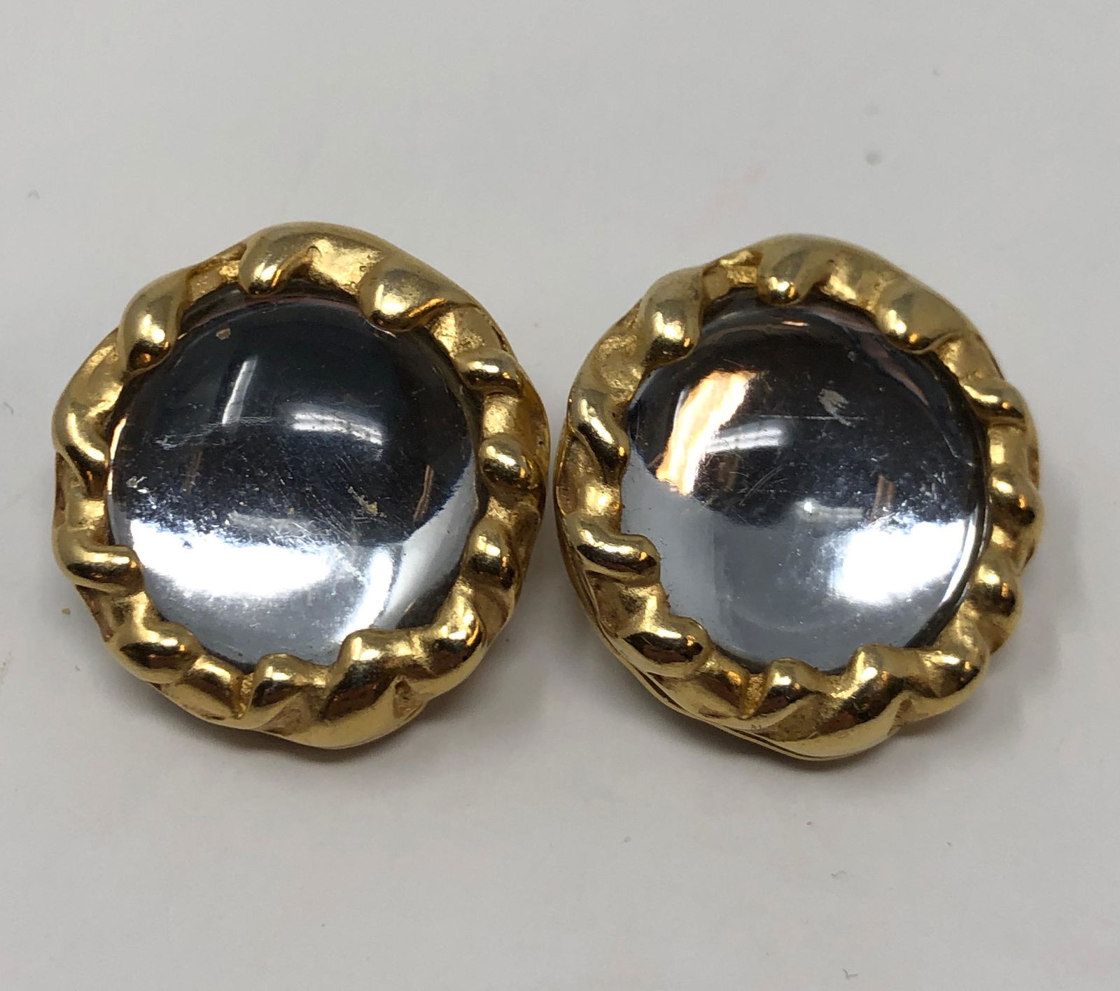 Vintage DKNY Clip on Earrings: Description: Splendid vintage DYNY clip on Earrings, set with large clear stone in a gold tone surround. Stamped on reverse side. Circa 1980s. Material: stone; metal. Measurement: approximate 1" (INCH