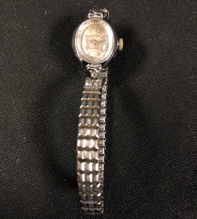 Waltham 17 Jewels Ladies Vintage Watch: Description: Waltham 17 Jewels Ladies vintage watch, elegant and timeless. Mesh band, small, oval champagne-color face; stainless back with base metal base; self winding. Material: glass; metal.