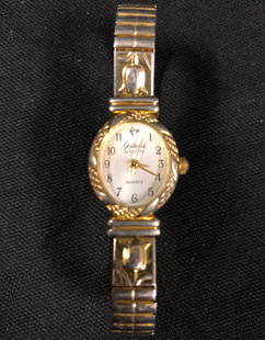 Vintage Elgin Galaxie Quartz Ladies Watch: Description: Vintage Elgin Galaxie Quartz ladies watch, serial number W1067. Pretty gold tone design, creamy white oval face with numbers, self winding, mesh band. Japanese movement, stainless back,