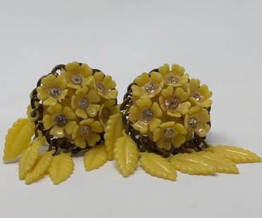 1940s Vintage Acrylic Yellow Flower Earrings: Description: 1940s vintage acrylic yellow flower earrings, charmingly embellished with small rhinestones and featuring small dangling leaves in yellow from bottom of earring. Set into a gold tone