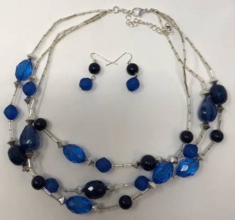 Pierced Earring and Necklace Set: Description: Stylish 3-strand necklace, set with dark blue beads on silver tone necklace with matching wire pierced earrings. Material: metal; plastic. Measurement: approximate 1.50" earrings/ 17"