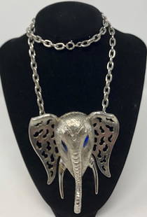 Vintage Celebrity Elephant Necklace: Description: High end Celebrity elephant necklace in silver tone metal with blue rhinestone eyes and clear rhinestone accents, open work ears. Wonderfully retro! Stamped on underside. Material: