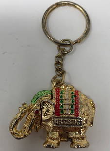 Vintage Elephant Keychain from Artistic: Description: Splendid bejeweled elephant keychain from Artistic. Crafted in bright, gold tone metal with a raised trunk for good luck! This is a very nice gift for any collector of elephant image.