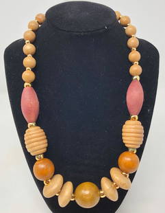 Vintage Wood Beaded Necklace: Description: Strikng vintage wod beaded necklace with beads of different sizes and shapes, accented with small, gold tone metal beads. Material: wood. Measurement: approximate 21" unclasped.