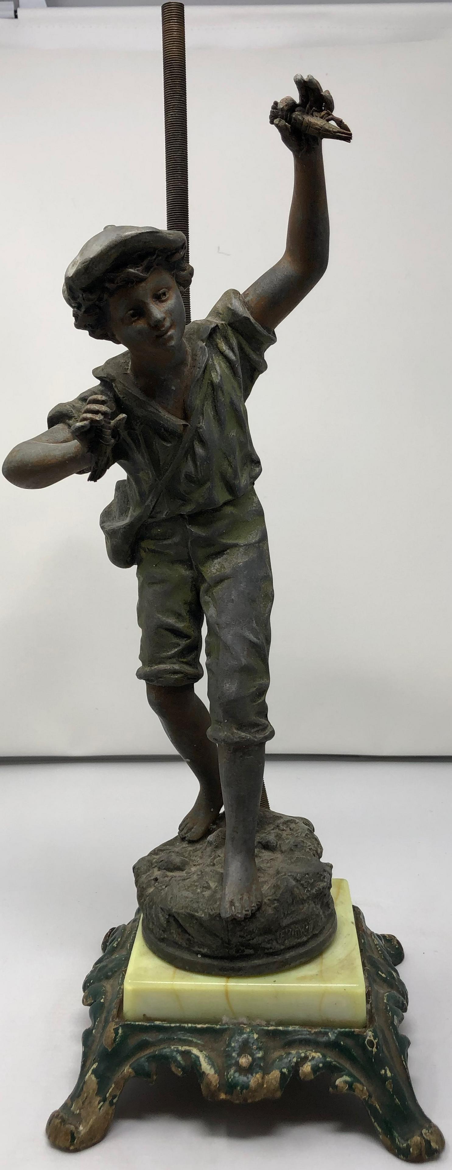 Signed Ernest Rancoulet Spelter, Boy figurine: Description: Signed Ernest Rancoulet figurine - boy standing on ledge with Lobster object . Material: spelter. Measurement: approximate 15.5" x 4.5" x 6" (INCHES). Shipping cost: $20. Different shippi