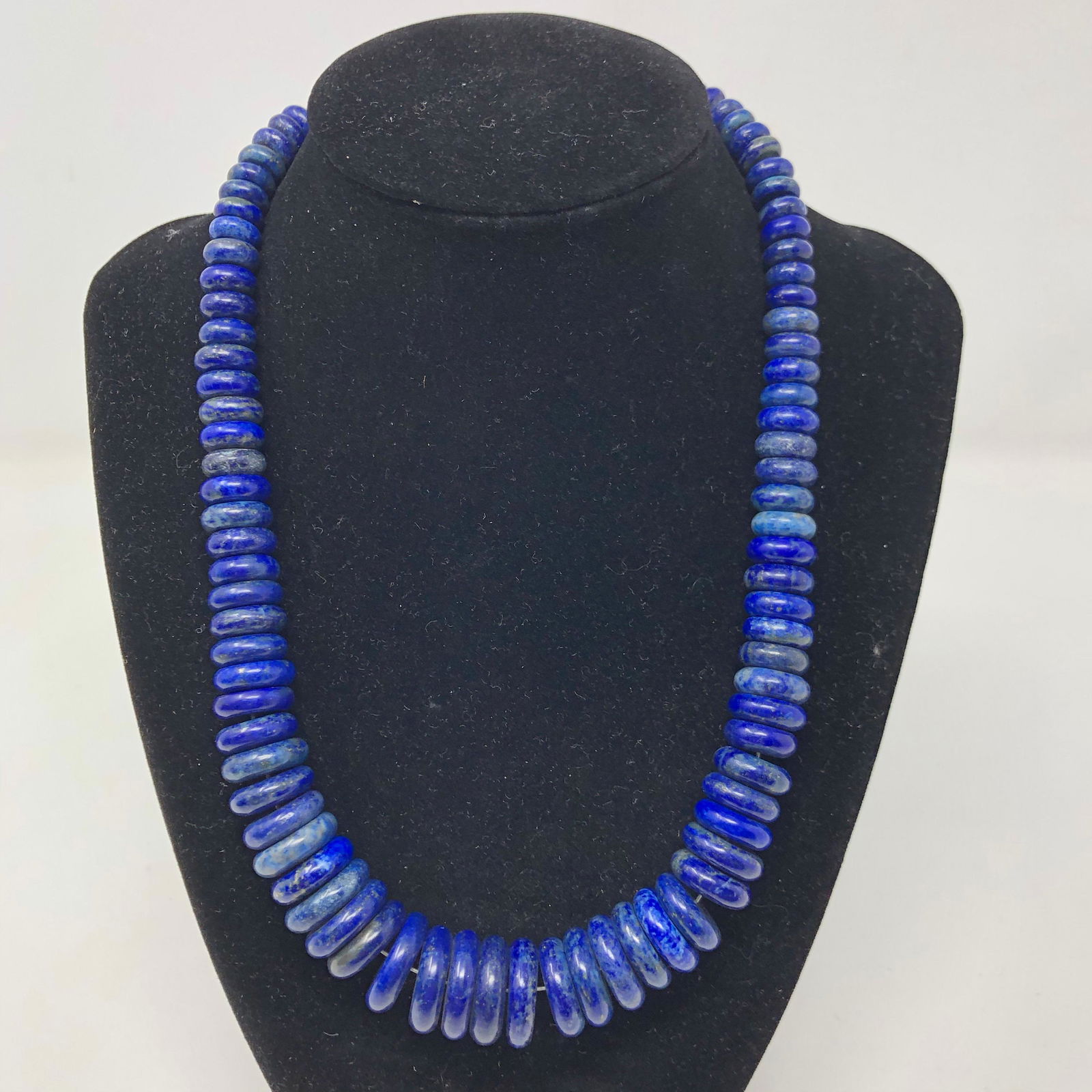 Deep Blue Lapis and Sterling Necklace: Description: Deep blue lapis and sterling necklace strung with polished discs and round beads of lapis lazuli capped with sterling. The beads of this necklace are slightly larger than the ones describ