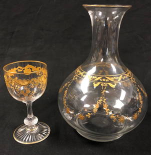 Vintage Glass Carafe & Cup with Gold Overlay: Description: Vintage glass carafe and matching petite aperitif-size glass, decorated with gold overlay in a garland pattern. Lip of pitcher and glass is lined in gold leaf. Material: glass; gold