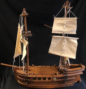 Tall Wooden Sailing Ship: Description: Old world style wooden sailing ship. Robust construction; 6 sails with black netting leading to 4 crows nests. Material: wood; cloth. Measurement: approximate 31"h x 31"w (INCHES).