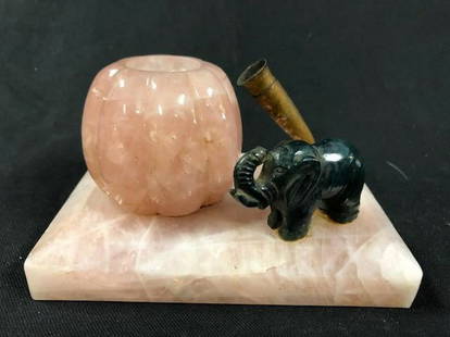 Delightful and Different Rose Quartz Desk Set: Description: Unique ink well and pen holder on stand embellished with small jade elephant. Beautiful rose quartz comprises stand and inkwell; brass pen holder along with diminutive dark green jade