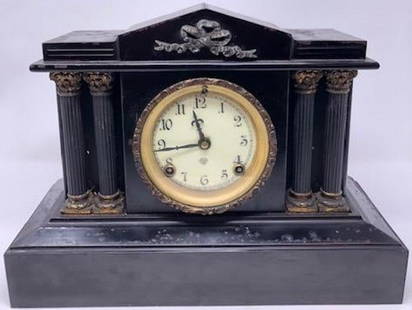 Gorgeous Ansonia Antique Mantel/Shelf Clock: Description: Gorgeous antique mantel/shelf clock, encased in black and designed to resemble a pillared Roman building. White enamel face with brass/metal accents. Material: marble; glass; enamel.
