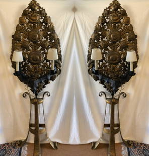 Outstanding and Unusual Brass Floor Lamps: Description: Outstanding and unusual pair of brass mid-century electric floor lamps with elaborate carved brass screens behind 2 small candle style sconces. The screens feature a floral pattern; the