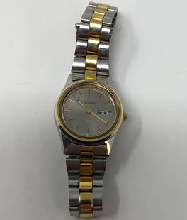 Classic Vintage Ladies Seiko Watch: Description: Classic ladies Seiko watch; two tone silver and gold tone metal; round face with date. Water resistant, stainless steel back, 3Y03-0A10, 870869. Japan movement. Material: metal; glass.