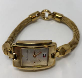 Tommy Hilfiger Bracelet Style Watch: Description: Tommy Hilfiger bracelet style ladies watch 80210. Pretty rectangular-shaped white face accented with gold tone metal. Material: metal; glass. Measurement: approximate size 7. Shipping: