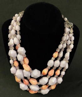 Shades of Summer Acrylic Beaded Torsade: Description: Right on time for (wishful thoughts of) warmer weather. Four strand torsade is strung with lovely lilac, pale pink/peach and clear beads; set on metal links with a 2" extender. Material: