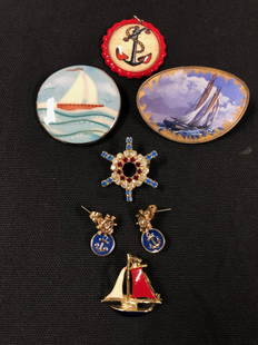 Vintage Seafaring Jewelry: Description: Seafaring jewelry collection including 3 sailboat themed brooches crafted in enamel over metal, one round anchor pin adorned with crystals, vintage nautical charm in red and pierced