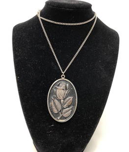 Vintage International Sterling Rose Flower Pendant and: Description: Pretty vintage signed International Sterling silver Rose flower large oval pendant and chain necklace. Suspended from non sterling, silver tone chain. Some slight wear to reverse side