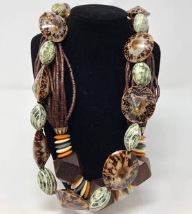 Rocking' Retro Belt and Necklace: Description: Retro set of brown and green belt paired with a brown wood beaded necklace, accented with green, cream and orange bead spacers. Belt has adjustable, tie closure. Material: wood;