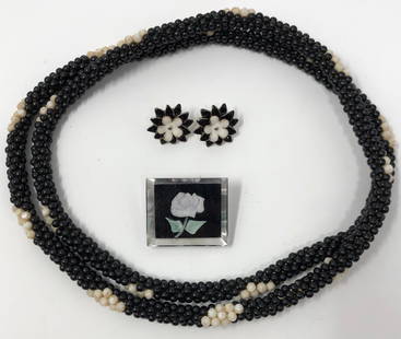 Black and White Vintage Jewelry Collection: Description: Simply superb set of vintage black and white jewelry including a long acrylic beaded, mid-century black and white necklace from the 1950s, enamel pierced floral black and white earrings