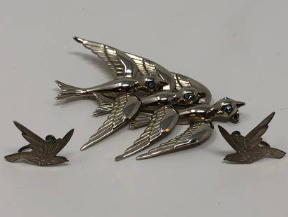 Lovely Birds in Flight Brooch and Earrings: Description: Lovely bright silver tone ladies brooch depicting 3 graceful birds in flight. The birds have light blue rhinestone eyes as accents. The non pierced, screw backing earrings are Mexican