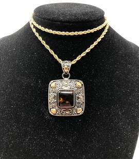 Avon Calling! Vintage Avon Amber Necklace: Description: Standout vintage Avon necklace with a square amber stone pendant set in sterling silver with 18 karat gold accents; hallmarked on reverse side. Suspended from an Avon gold tone rope