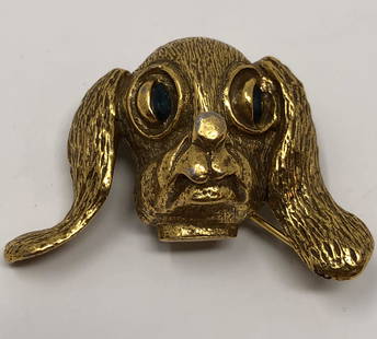 Vintage Cocker Spaniel Brooch: Description: Whimsical depiction of a soulful-eyed cocker spaniel, crafted in gold tone metal with green rhinestone eyes. Material: metal; glass. Measurement: approximate 1.25" (INCHES). Shipping: