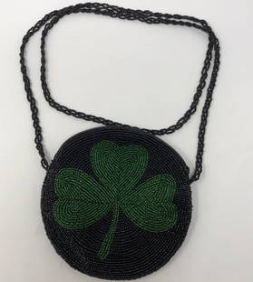 Small Black and Green Shamrock Evening Bag: Description: Delightful small round beaded bag with black and green beads. Center of bag is decorated with a green beaded shamrock. Beaded shoulder strap, zippered closure, black polyester lining.