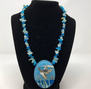 Gorgeous Vintage Lee Sands Inlay Necklace: Description: Beautiful blue shell inlay Lee Sands necklace, featuring a water fowl in flight against a water and sky background, suspended from a blue beaded chain. The pendant is crafted from