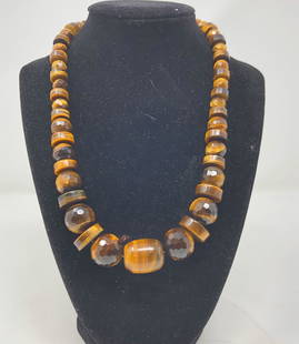 Vintage Tiger Eye Necklace w/Sterling: Description: Arresting vintage necklace of tiger eye beads, capped with sterling tips. The gemstone Tiger eye properties are attributed closely to behavior of the tiger. The golden-brown quartz is