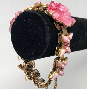 Beautiful to Behold Vintage Rose Bracelet: Description: Absolutely lovely vintage bracelet adorned with carved pink roses, interspersed with pink stone flowers and pink crystals set in gold tone metal. The craftsmanship is of the highest