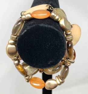 Faux Mixed Stone Ladies Stretch Bracelets: Description: Twice as nice! Set of two faux mixed stone ladies stretch bracelets in lovely shades of amber, brown and champagne. Material: Glass; plastic. Measurement: approximate ladies size 7.