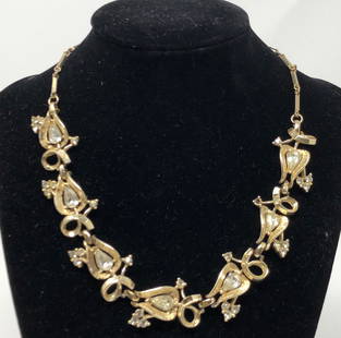 Vintage Coro Gold Tone, Crystal Necklace, Signed: Description: Absolutely elegant vintage Coro gold tone, clear crystal necklace, signed. Choker-style (very Betty Draper-ish) with burnished gold tone links set with 7 large, faceted clear,