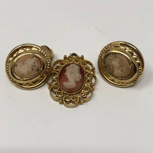 Cameo Clip Earrings and Pendant: Description: Elegant vintage pairing of cameo clip-on earrings with a cameo pendant, set in delicate filigree gold tone metal. Material: metal. Measurement: approximate 1” pendant/1” earrings