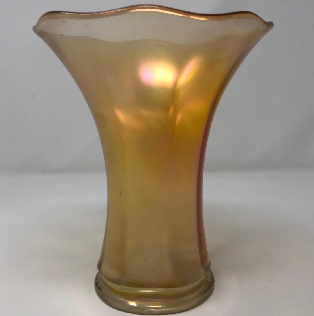 Vintage Orange Glass Vase: Description: Lovely vintage orange glass vase, shaped in a fluted pattern with milky, opalescent base. Bubbles at rim may indicate this vase is hand blown; very distinctive in color and appearance. Ma