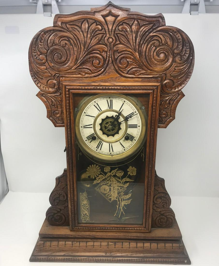 Vintage Waterbury mantel/mantle Clock, ornate wood: Description: 8 day Felix strikes half hours, Waterbury standing clock or wall hanging, with hook in rear.6" face, glass front 12" x 6", below clock face on front glass is ornate flower gold leaf style