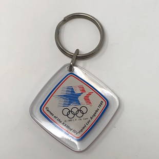 GAMES OF THE XXIIIrd Olympiad Los Angeles 1984 KeyChain: GAMES OF THE XXIIIrd Olympiad Los Angeles 1984 KeyChainApproximate measurements: 3 x 2 inches;Materials: metal, lucite, paper;Condition: used, good;Shipping cost: $12. Different rate to California,