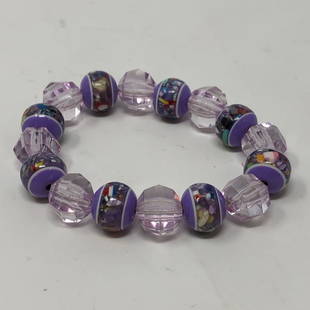 Purpley Flower Stripes & Clear Beads Alternating: Purpley Flower Stripes & Clear Beads Alternating Stretchy BraceletApproximate measurements: 2.5 inches diameter stretchy;Materials: elastic fabric, beads;Condition: used, good;Shipping cost: $12.