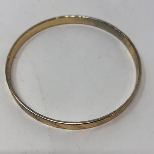 Pretty Golden toned slant design slip on bangle: Pretty Golden toned slant design slip on bangle braceletApproximate measurements: 3 inches across x 0.25 wide;Materials: Gilted metal, fabric, stones;Condition: used, good;Shipping cost: $12.