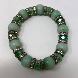 Lucky Jadelike stretchy green & silvery contrast: Lucky Jadelike stretchy green & silvery contrast delightApproximate measurements: 3 inches across x 0.5 inches;Materials: Beads, fabric, elastic, clear stones;Condition: used, good;Shipping cost: