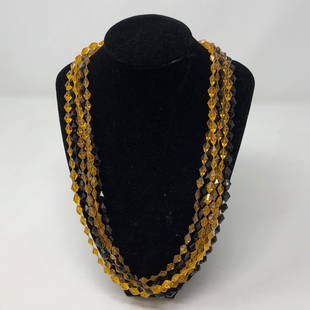 Golden Amber & Black 2 to 1 strands STUNNING VINTAGE: Golden Amber & Black 2 to 1 strands STUNNING VINTAGE necklaceApproximate measurements: 96 inches total length;Materials: Amber & Black 8 sided beads;Condition: used, good;Shipping cost: $12.