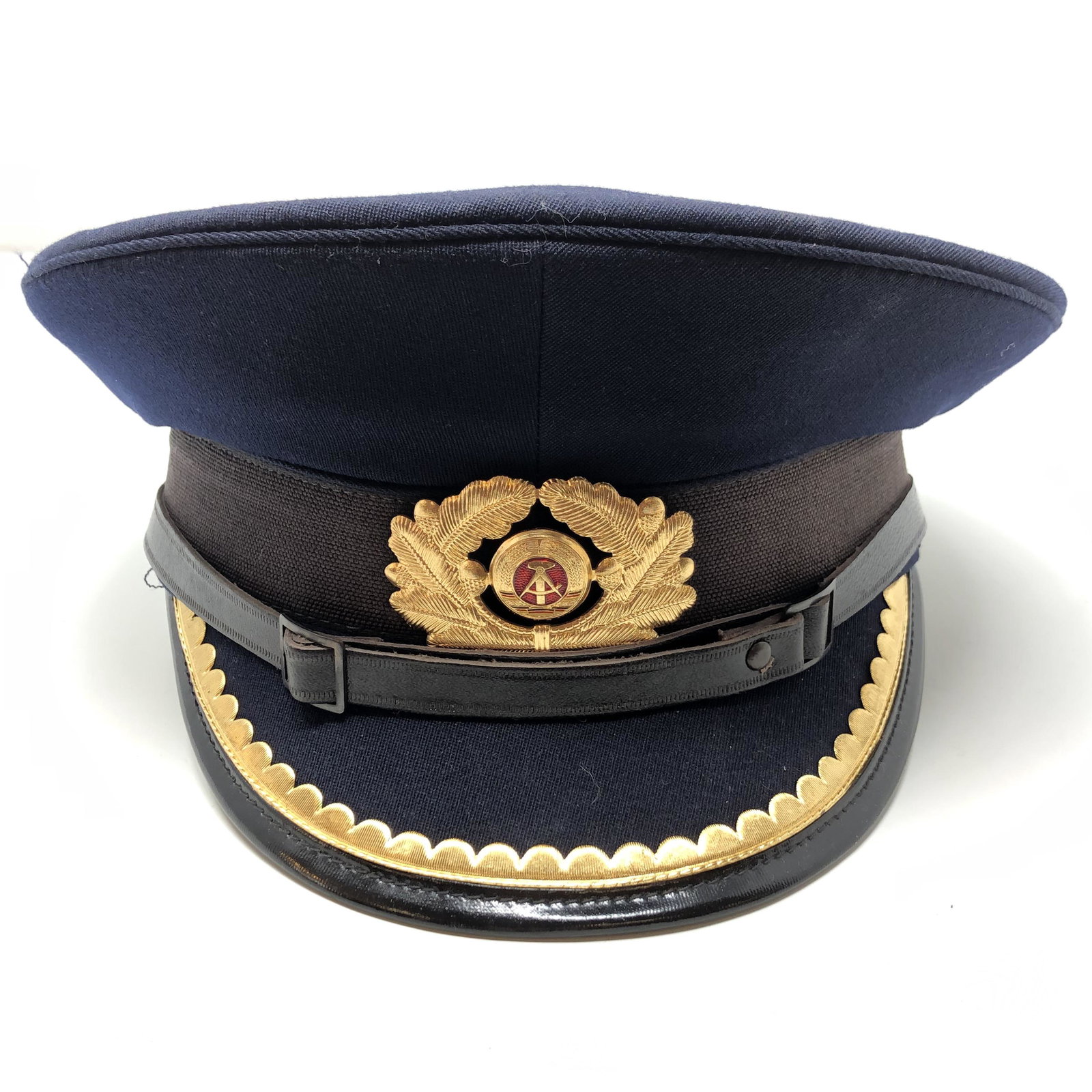 Vintage NVA 56 1856 P Military Police Hat W/ Visor: Vintage NVA 56 1856 P Military Police Hat W/ Visor Officer East Germany German APPROXIMATE MEASUREMENTS: 10 inches round x 5.5 inches MATERIALS: Fabric, leather, metal, plastique SHIPPING COST: $25. D