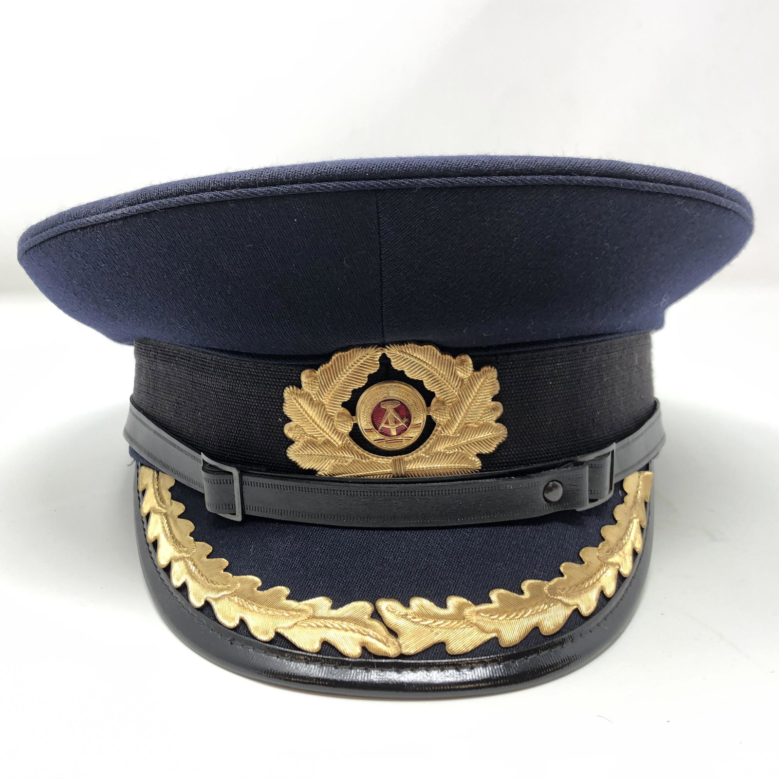 Vintage NVA 56 1856 P Military Police Hat W/ Visor: Vintage NVA 56 1856 P Military Police Hat W/ Visor Officer East Germany German APPROXIMATE MEASUREMENTS: 10 inches round x 5.5 inches MATERIALS: Fabric, leather, metal, plastique SHIPPING COST: $25. D