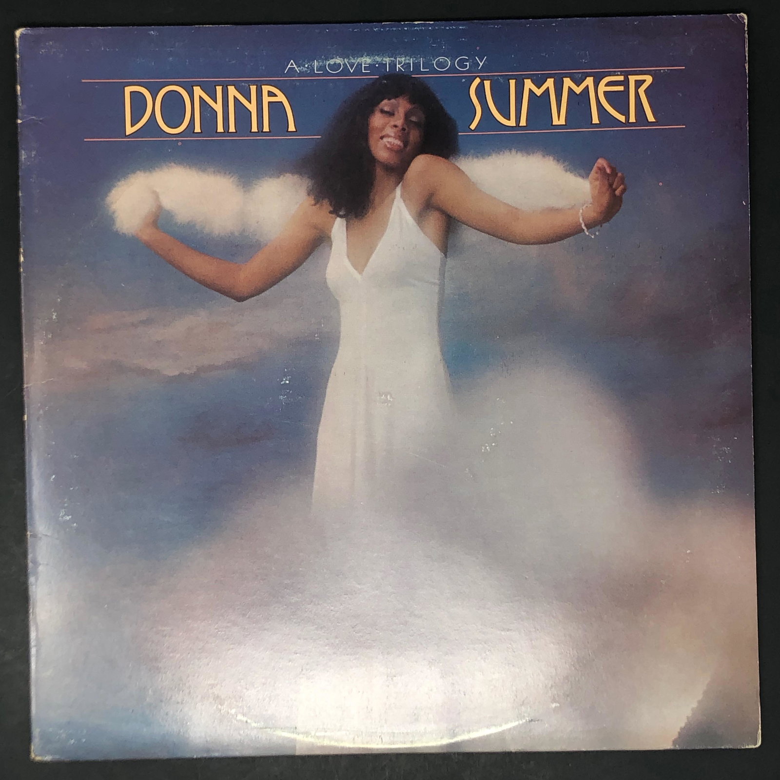 Vinyl LP Donna Summer / A LOVE TRILOGY: Description: Vinyl LP Donna Summer / A LOVE TRILOGY. Approximate measurements: 12.25 x 12.25 inches. Materials: vinyl, cardboard & or paper.