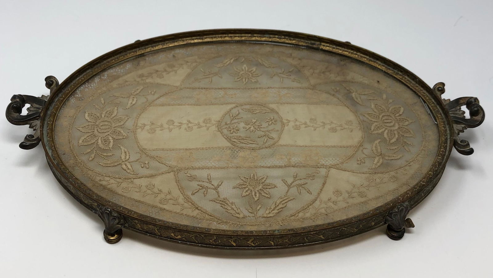 1920s Antique Apollo Studios Vanity tray / with lace insert: Description: 1920s Antique Apollo Studios Vanity glass footed tray/with lace insert. Item is marked Apollo & Co and numbered. Measurement approximate: Material: Silverplate/ Lace