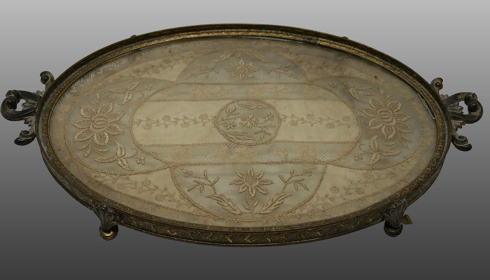 1920s Antique Apollo Studios Vanity tray / with lace insert: Description: 1920s Antique Apollo Studios Vanity glass footed tray/with lace insert. Item is marked Apollo & Co and numbered. Measurement approximate: Material: Silverplate/ Lace