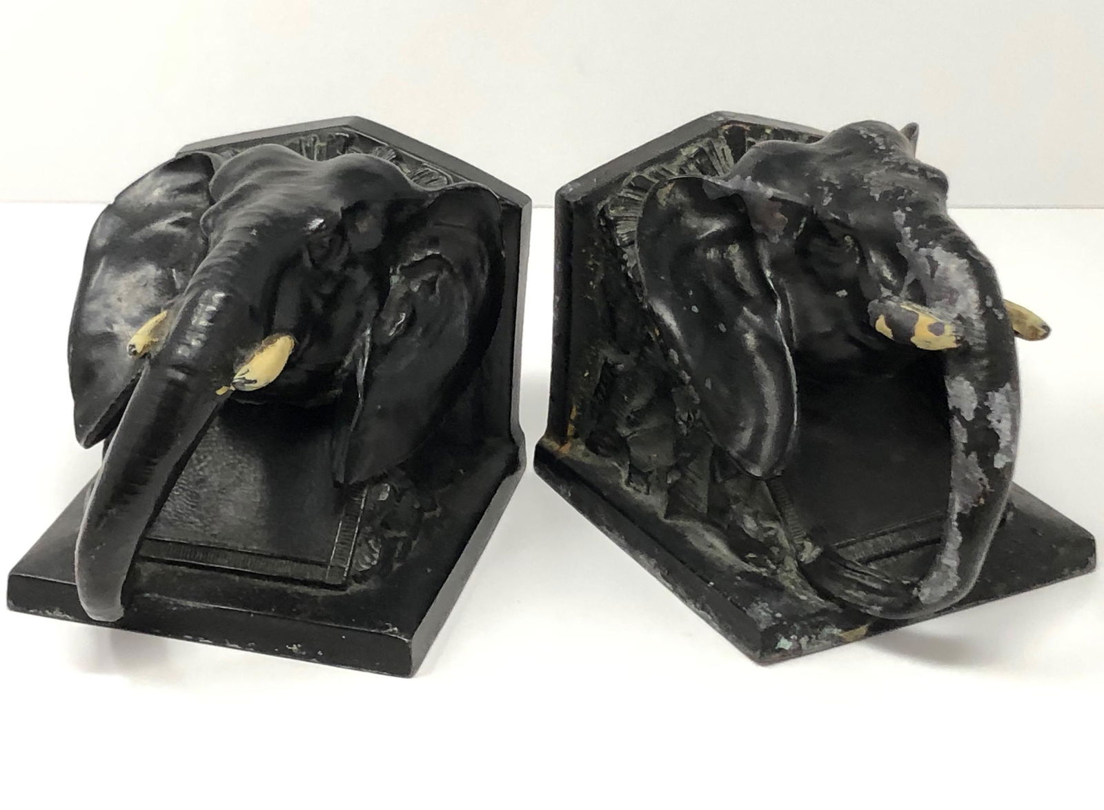 Pair Cast Iron Elephant Book End Sculpture: Description: Pair Cast Iron Elephant book end sculpture. Measurement approximate: 5"l x 4"w x 4"h (each); Material: Bronze. This item has a reserve price.