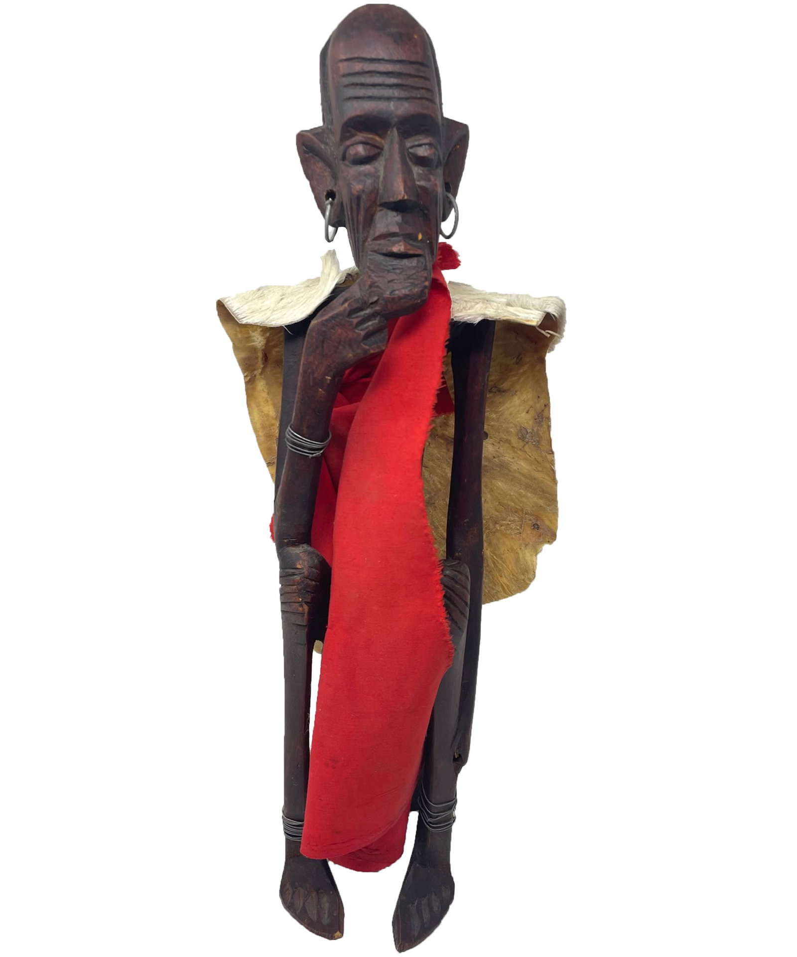 Kenya Male statue with hoop earrings wearing red cape & animal skin: Description: Kenya Male statue with hoop earrings wearing red cape & animal skin; Materials: Wood; Measurements: 19 x 7